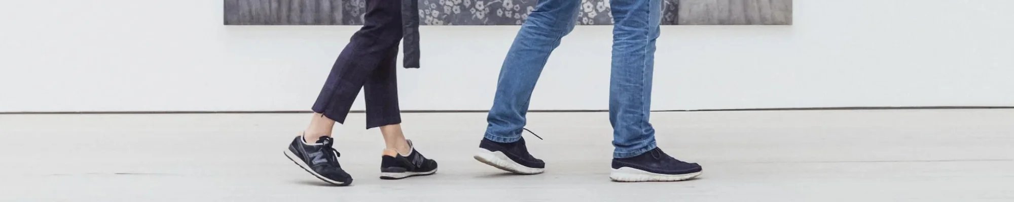 People walking in a bright commercial building with white floor